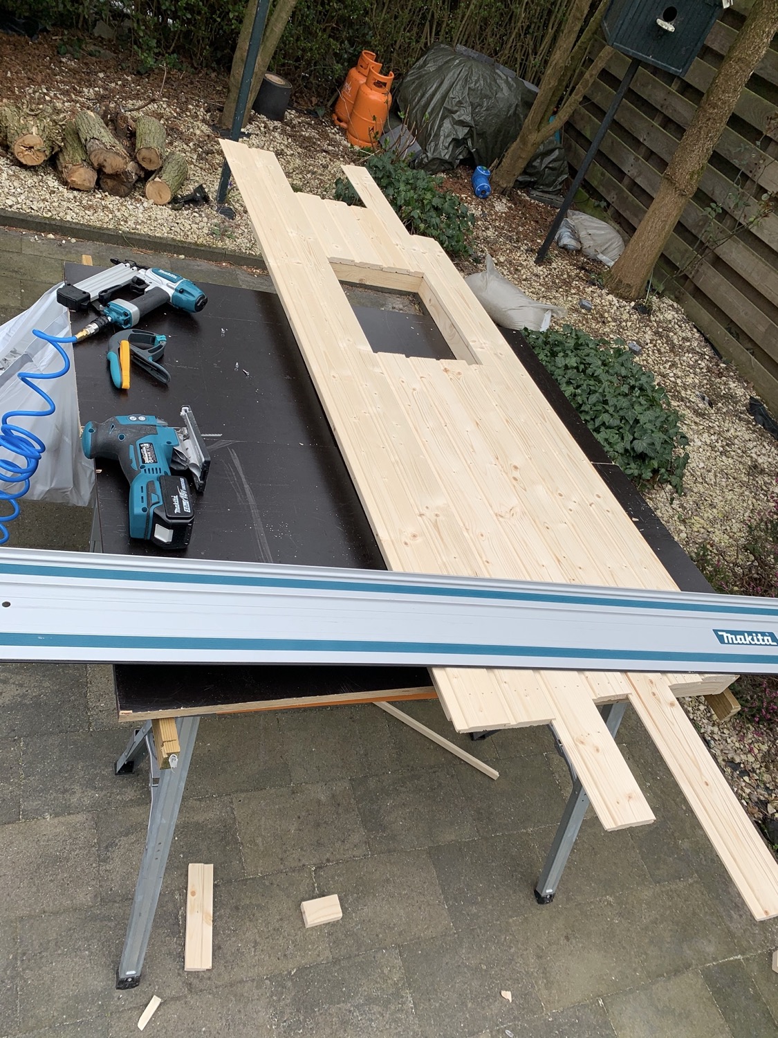 Sawing of the excess wood paneling on the door.