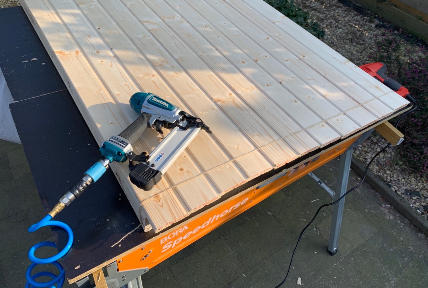 Adding the wood panelling and nailing it to the frame (I used 18G brad nails). I had all panels overhang the frame a bit and then sawed off the overhang all at once to get a nice straight and even cut.