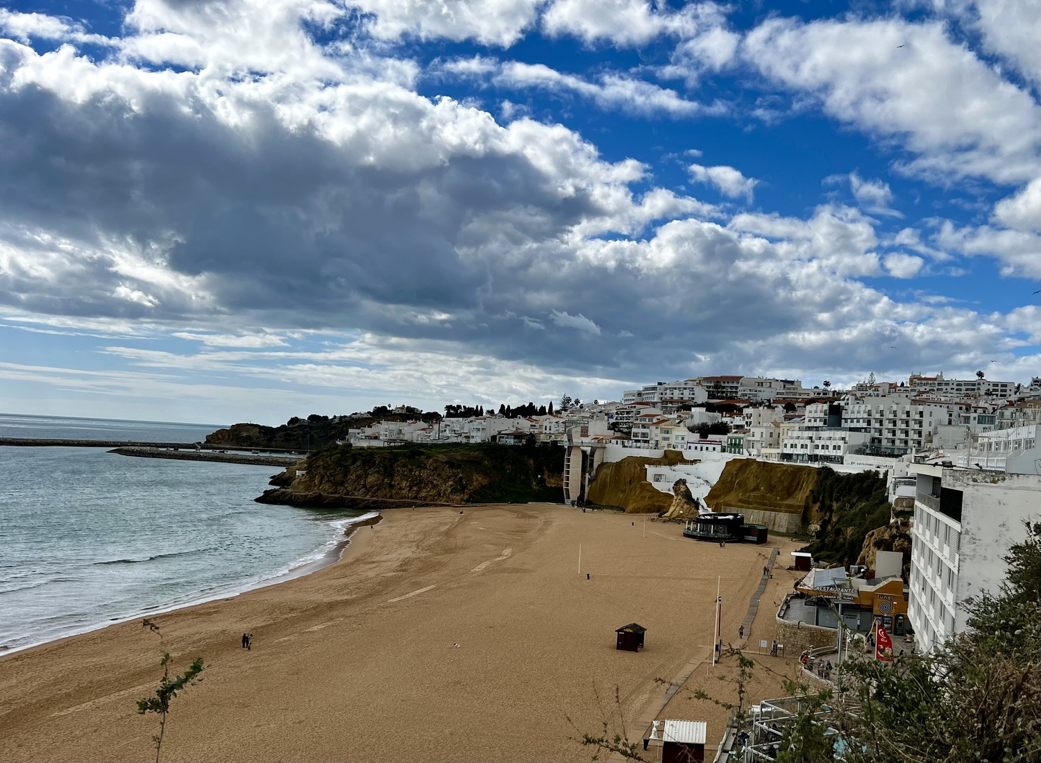 Visiting *Albufeira.* We ended up having lunch in the round black restaurant in the distance on the beach!